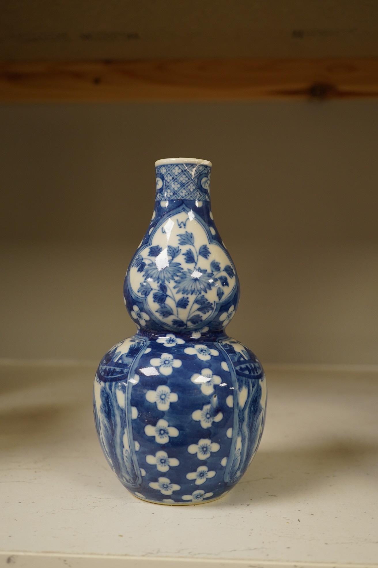 Two Chinese vases; a blue and white double gourd vase and famille noir vase, famille noir 19cm high. Condition - good